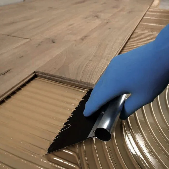 Mapei Ultrabond Eco S955 1K Wood Floor Adhesive being applied with a trowel